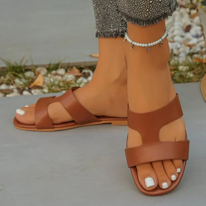 Sandalias planas tipo mule de mujer con tira única y corte calado, ajuste ancho, de PU, sin talón, antideslizantes, con suela fina, ideales para el verano, viajes a la playa y tallas grandes.